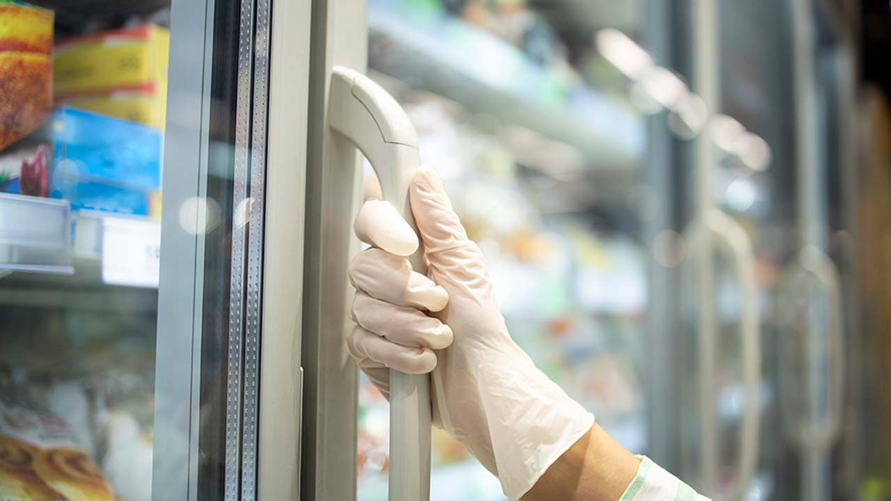 Someone opening a display freezer